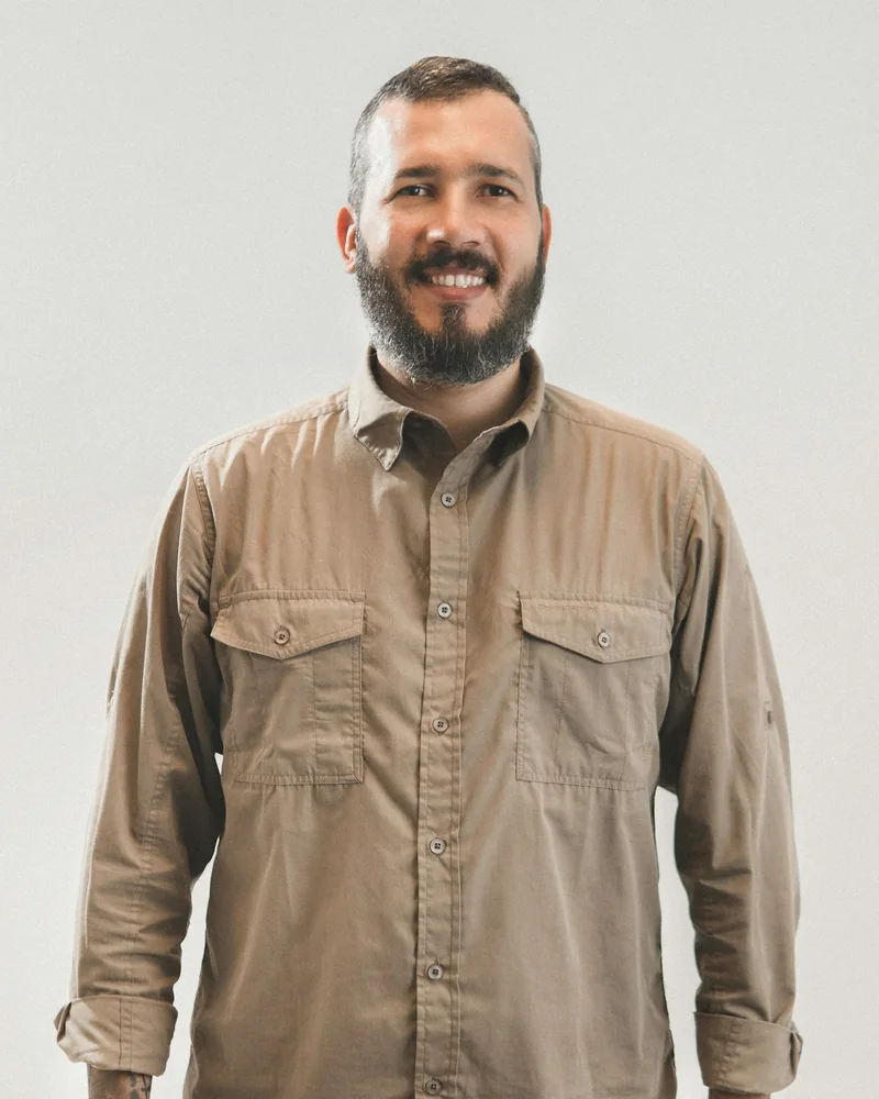 Dale Wexler, a bearded man in a tan work shirt with the sleeves rolled, smiling.